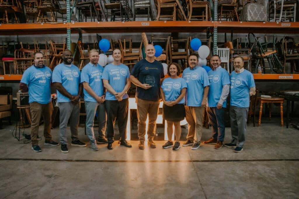 People Taking A Picture In A Warehouse.