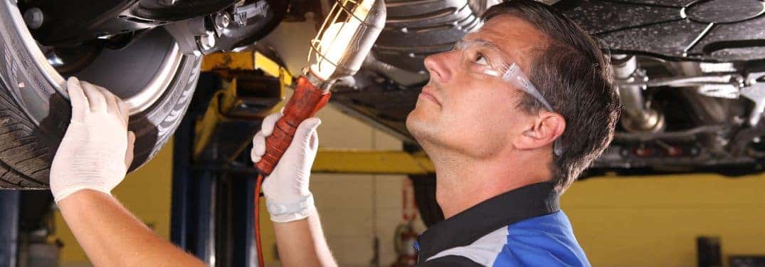 Volkswagen Technician Under a Lifted Vehicle