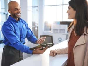 VW Service Advisor Helping a Customer