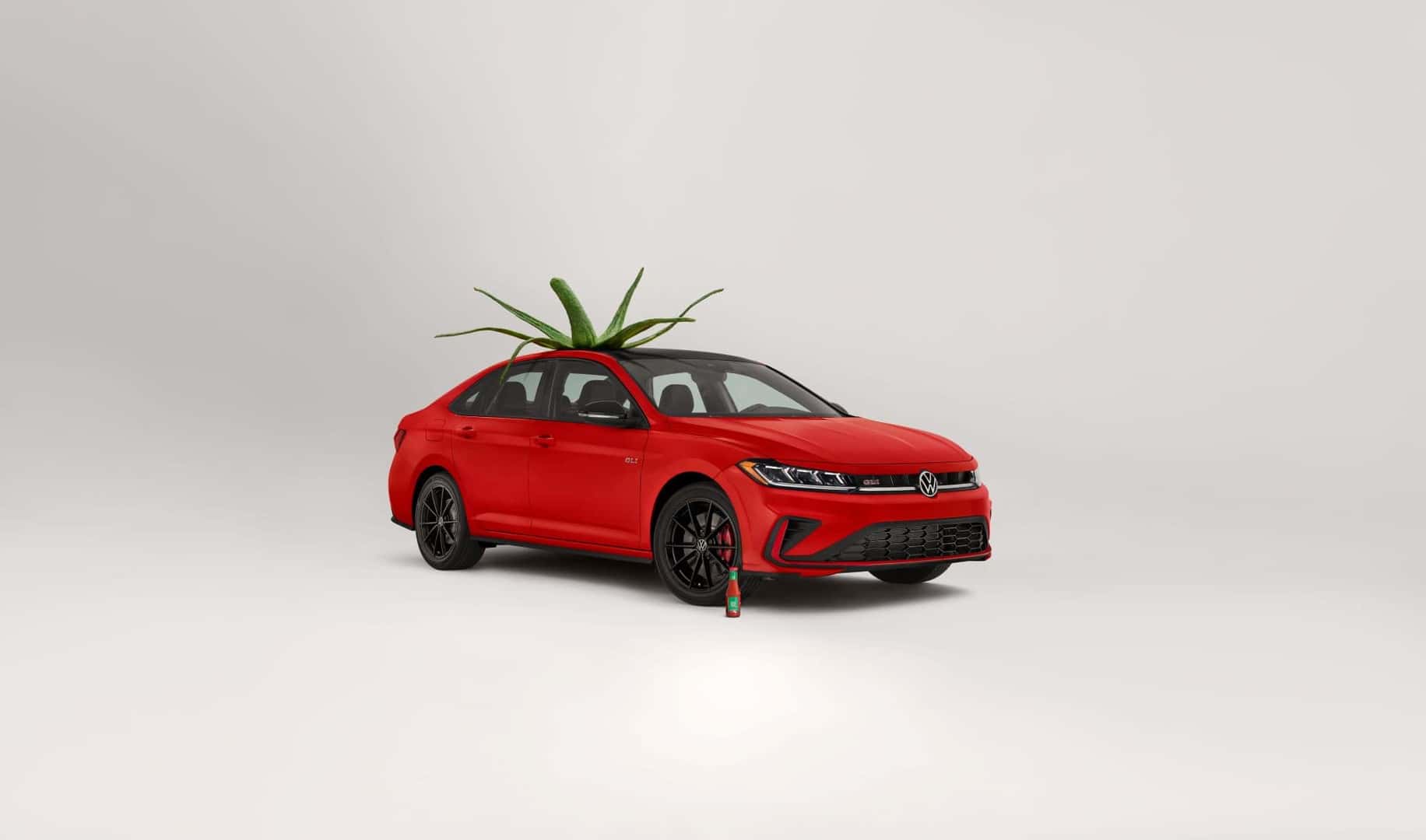 A VW Red Car Is In A Tomato Costume, With The VW Ketchup Posed In Front Of Its Sexy Front-Right Wheel