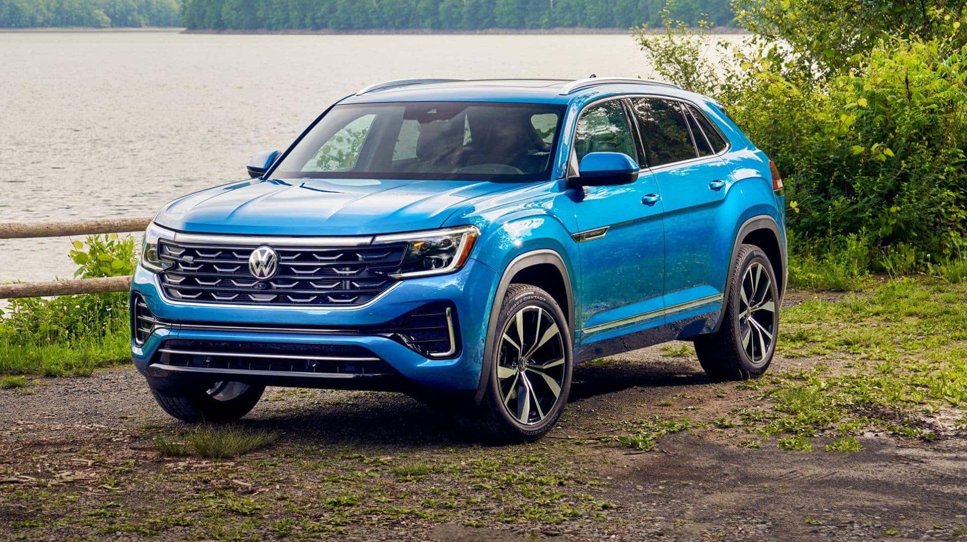 The VW Atlas Cross Sport, A Dashing Blue And Parked Beside A Lake