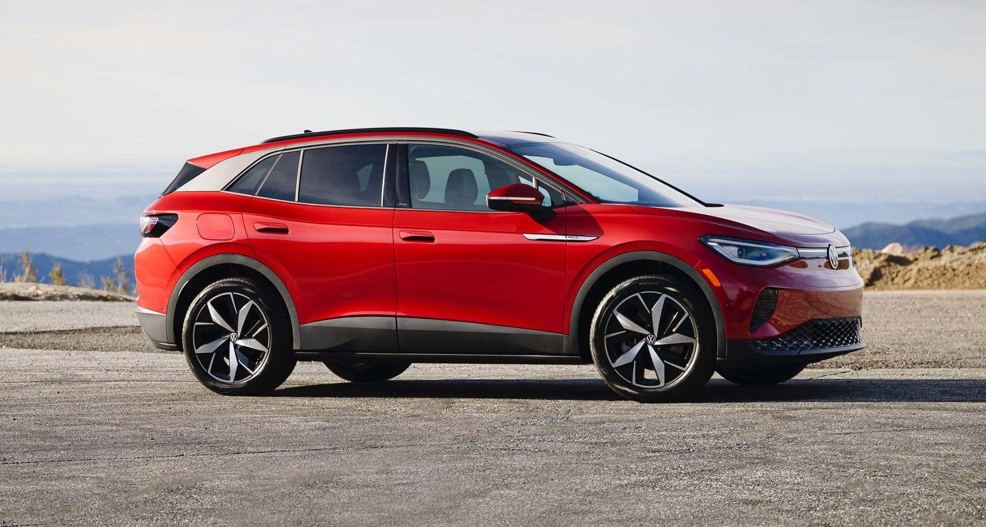 The Sleek Red Side Profile Of A Volkswagen Vehicle