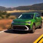 2025 Volkswagen Taos SEL Bright Moss Green Metallic in motion