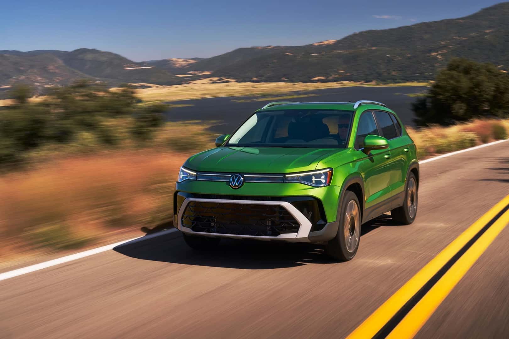 2025 Volkswagen Taos SEL Bright Moss Green Metallic in motion