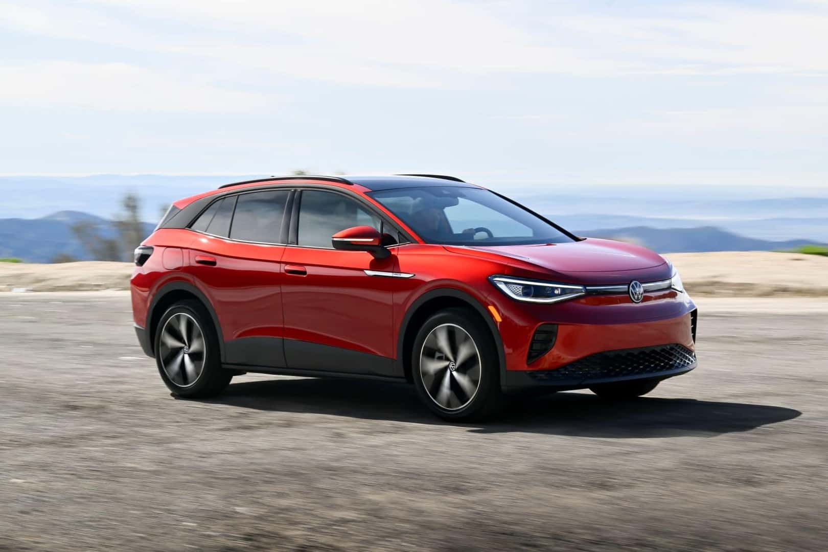 The Sexy Red Exterior Of The 2024 Volkswagen ID.4, Charging On The Concrete