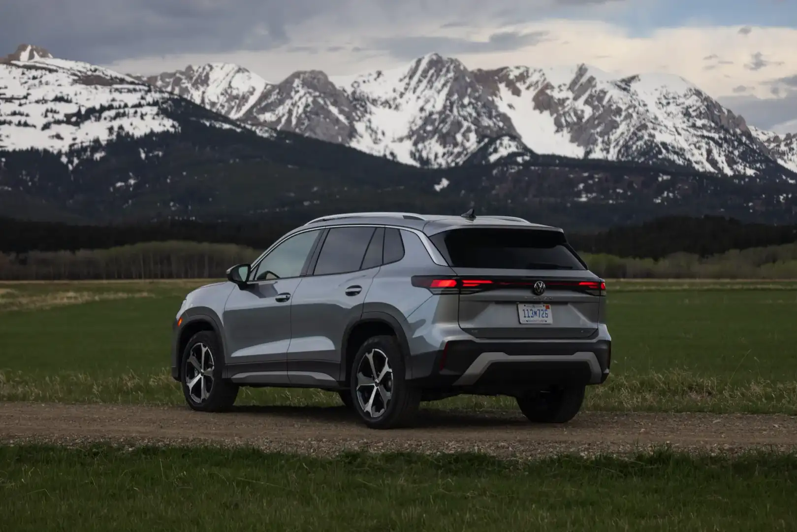 2025 silver VW Tiguan rear view in front of mountains
