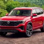 2025 Red VW Atlas parked off road view of the front parked in nature in front of lush trees