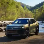 2026 VW Tiguan SEL R Line Avocado exterior front view parked off road in front of a river