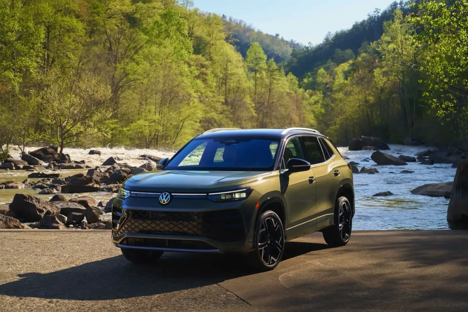 2026 VW Tiguan SEL R Line Avocado exterior front view parked off road in front of a river