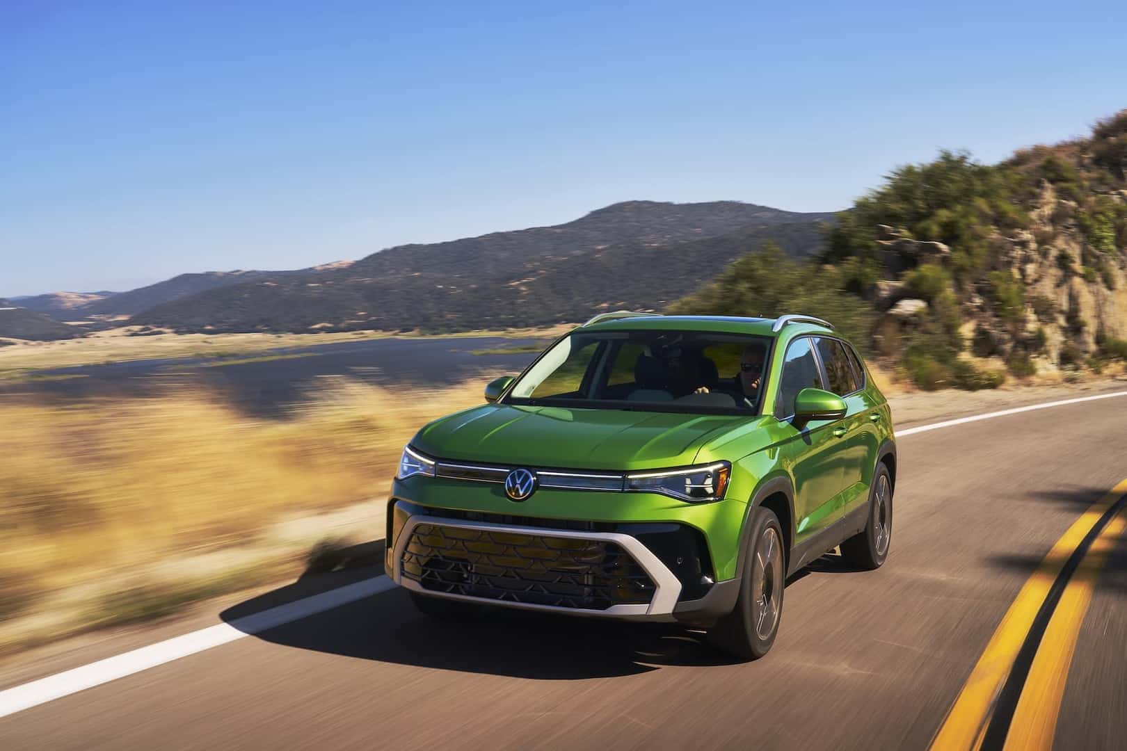 2025 Volkswagen Taos Bright Moss Green Metallic in motion