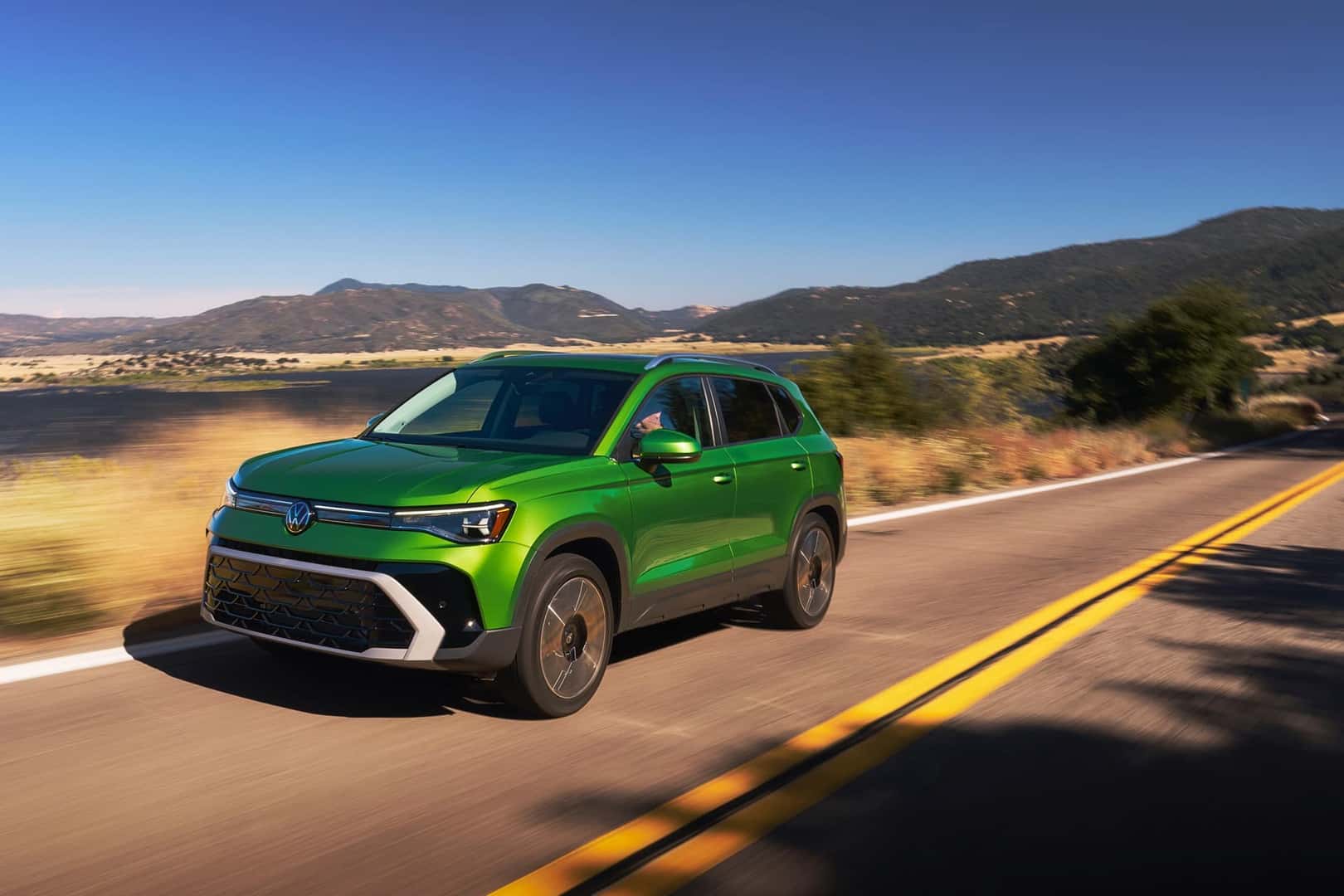 2025 Volkswagen Taos Bright Moss Green Metallic in motion