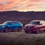 Two Beautiful And Reliable Volkswagen Atlas' Parked In Natural Terrain During Dusk