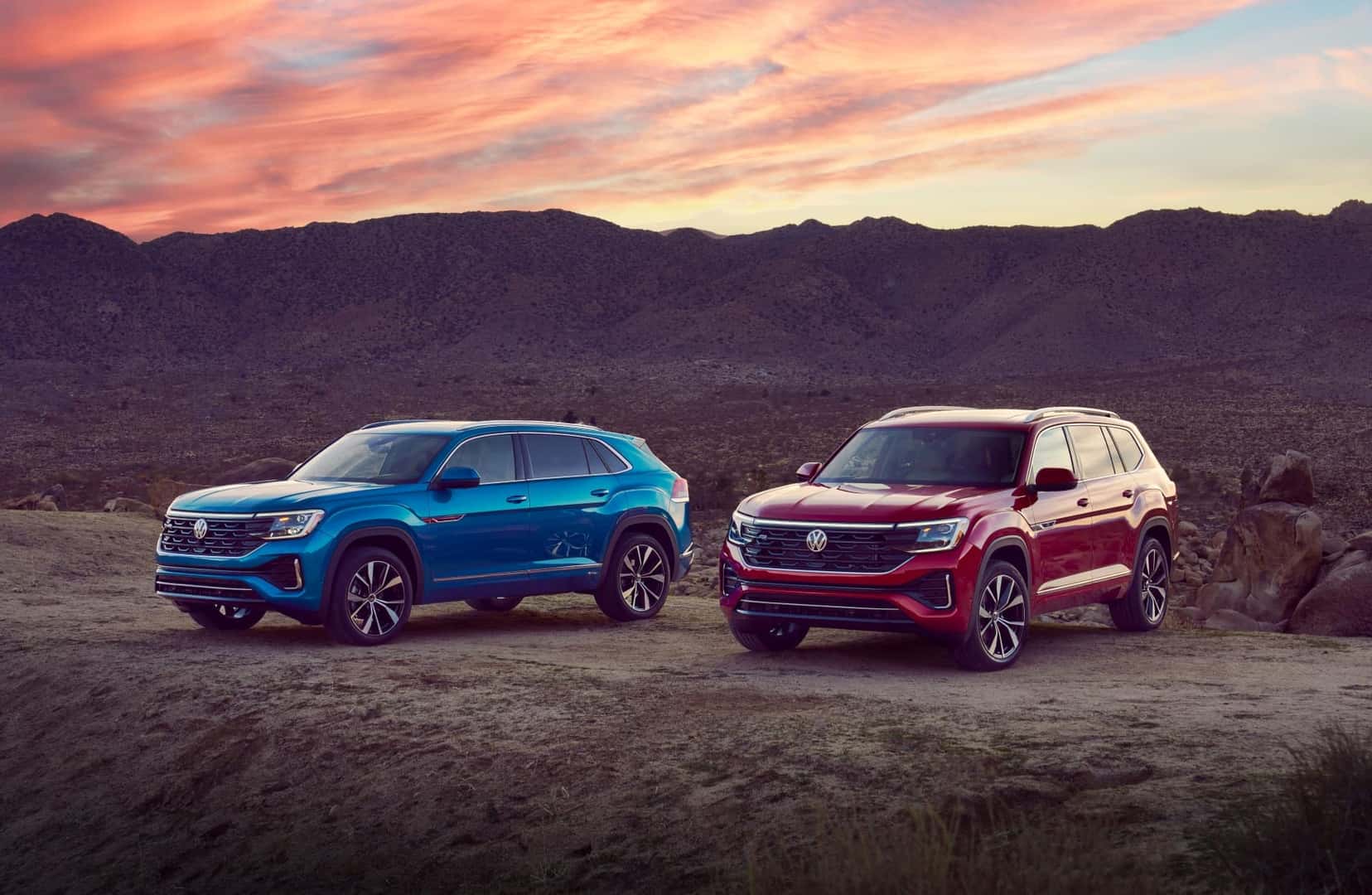 Two Beautiful And Reliable Volkswagen Atlas' Parked In Natural Terrain During Dusk