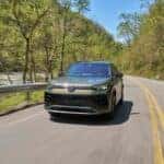 The Award-Winning And High-Quality 2026 Volkswagen Tiguan SEL R-Line Turbo Driving On The Highway Past Trees And Iron Rails