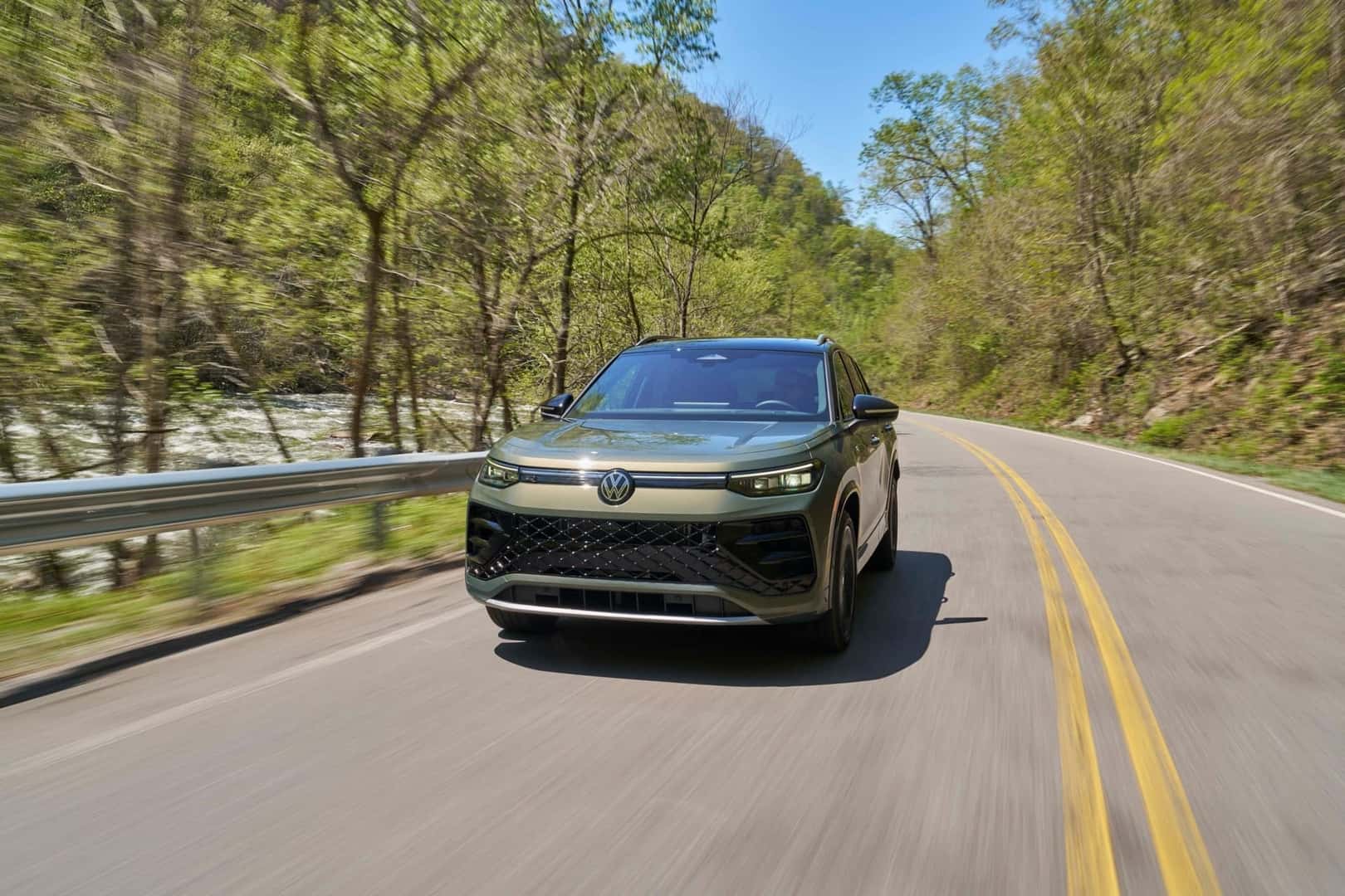 The Award-Winning And High-Quality 2026 Volkswagen Tiguan SEL R-Line Turbo Driving On The Highway Past Trees And Iron Rails