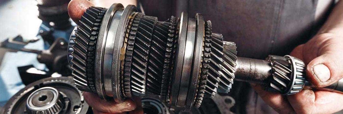 Close up view of a service tech holding a transmission component