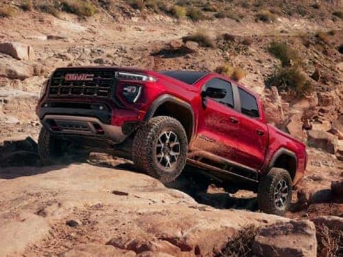 2024 GMC Canyon AT4 driving up a rocky hill