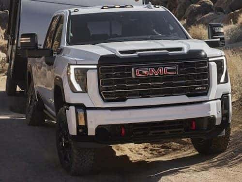 2024 GMC Sierra HD AT4 towing an enclosed trailer
