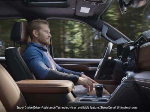 2025 GMC Sierra 1500 side view of man in driver seat while vehicle is in supercruise mode