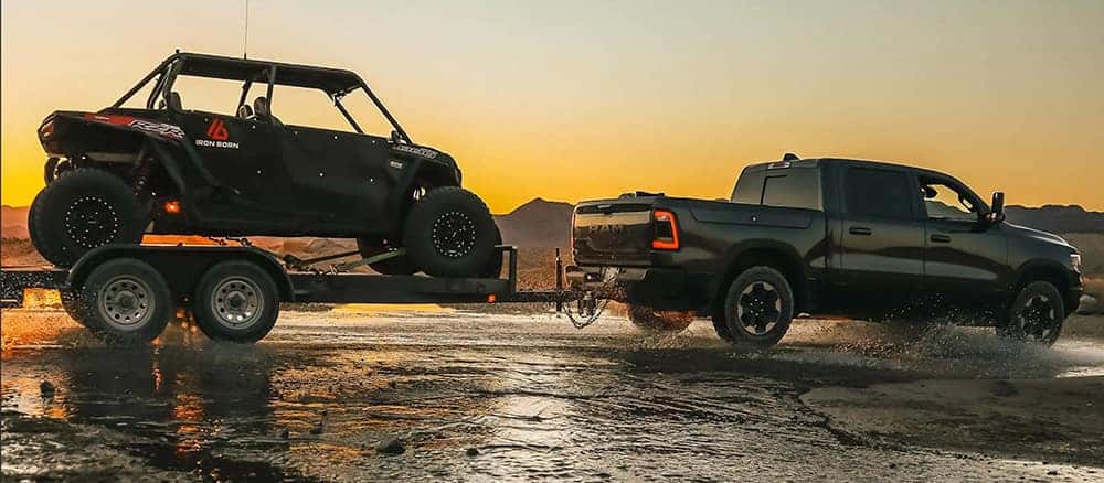 Ram 1500 Pulling a side by side on a trailer