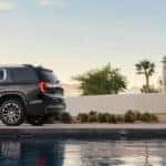 GMC Acadia Parked Outside Beautiful Home with In-Ground Pool