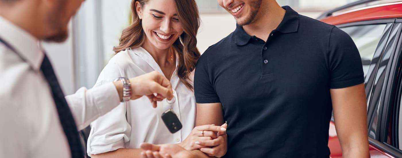 A couple is shown talking to a salesperson.