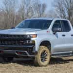 A grey 2023 Chevy Silverado 1500 Trail Boss is shown from the front at an angle.
