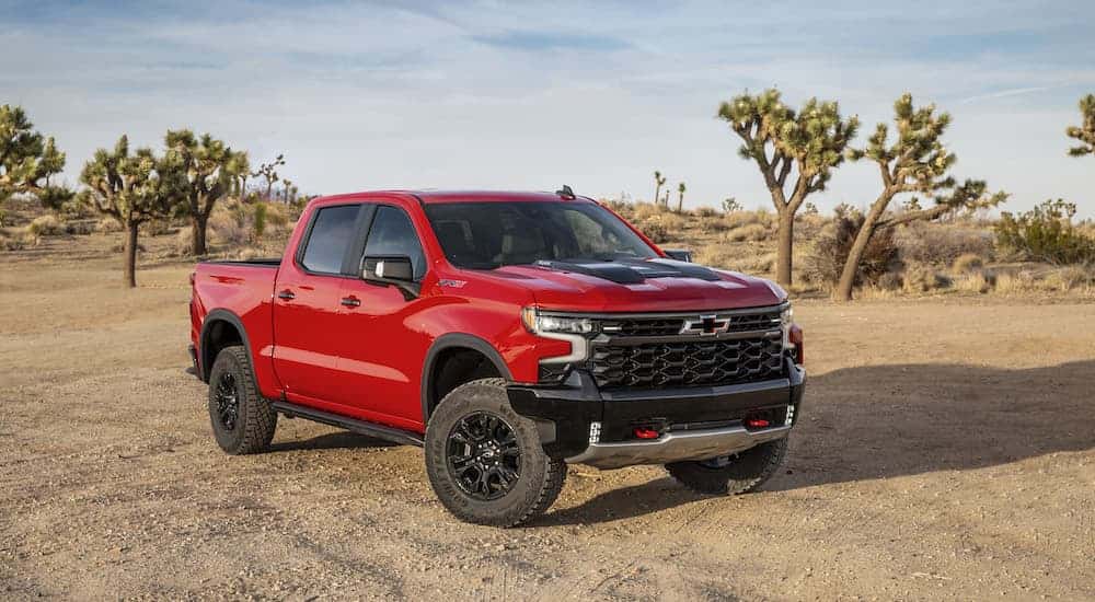 A red 2023 Chevy Silverado 1500 ZR2 is shown from the front at an angle after leaving a dealer that has a Chevy Silverado for sale new Trussville, AL.
