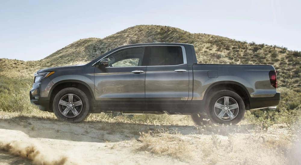 A grey 2021 Honda Ridgeline RTL-E is shown from the side.