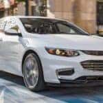A white 2016 Chevy Malibu is shown from the front at an angle.