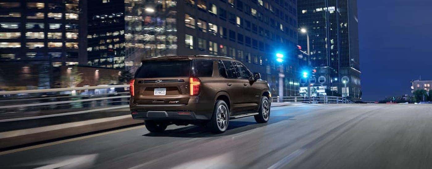 A brown 2022 Chevy Tahoe RST is shown from the rear at an angle after the owner searched how to 'sell my car'.