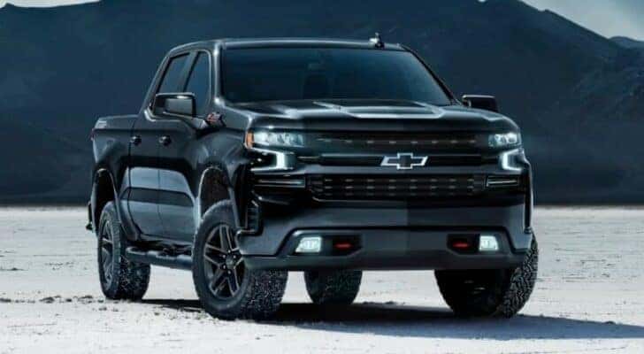 A black 2024 Chevy Silverado 1500 Z71 Midnight Edition is shown parked off-road.