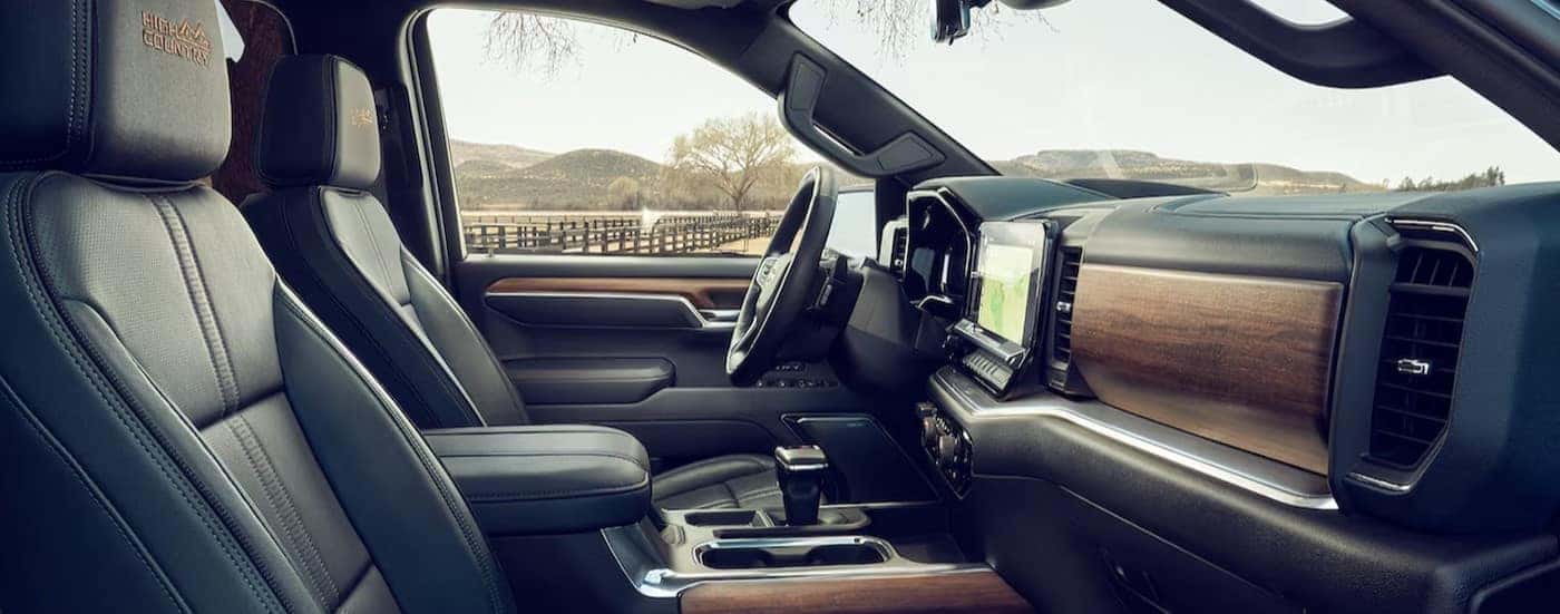 The black and brown interior and dash in a 2024 Chevy Silverado 1500 High Country is shown.