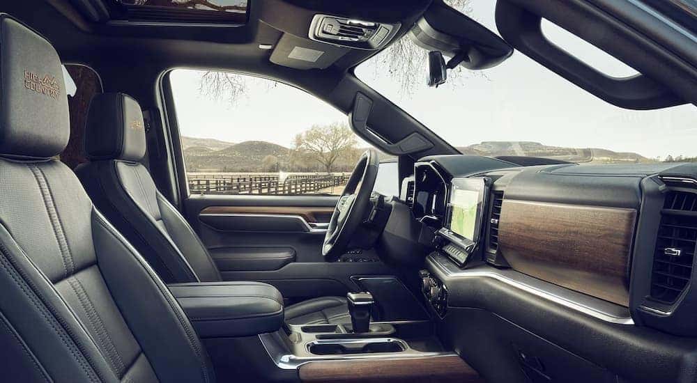 The wood and leather interior of the High Country trim of a 2024 Chevy Silverado 1500 for sale near Trussville.