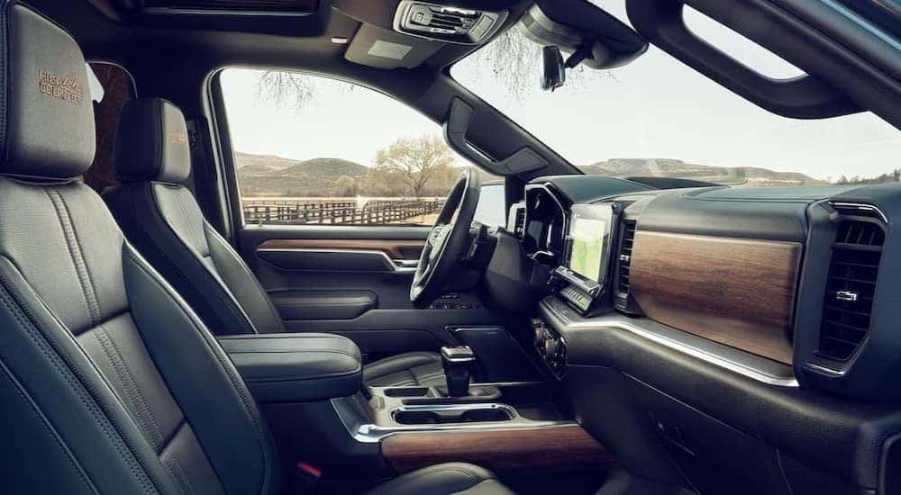 The black and brown interior and dash in a 2024 Chevy Silverado 1500 High Country is shown.