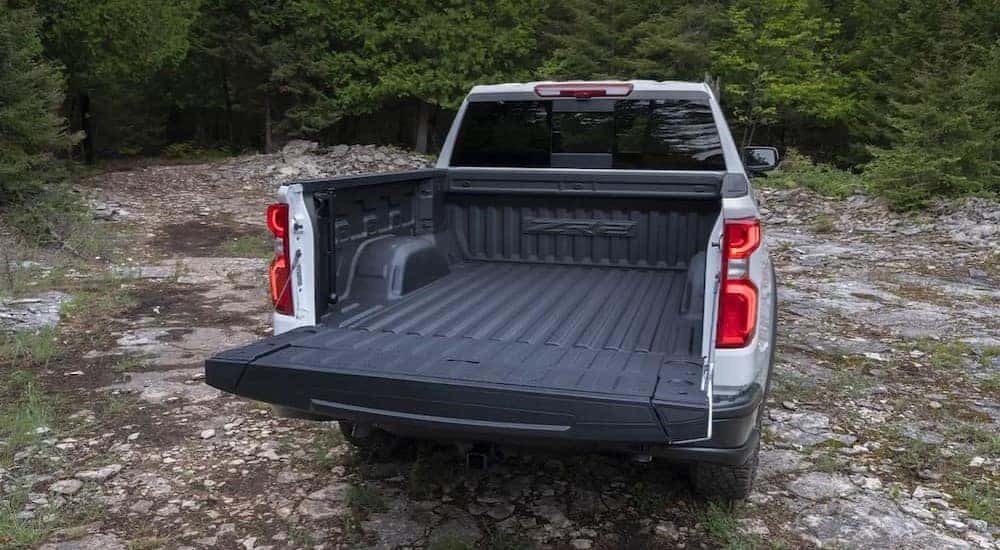 A rear view of the open tailgate on a white 2024 Chevy Silverado 1500 ZR2.