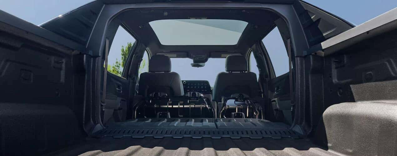 The open Multi-Flex Midgate of a black 2024 Chevy Silverado EV.