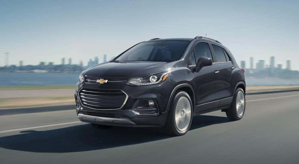 A gray 2020 Chevy Trax is shown driving near a city.