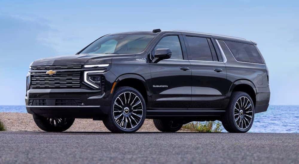 A black 2025 Chevy Suburban High Country parked and angled left.