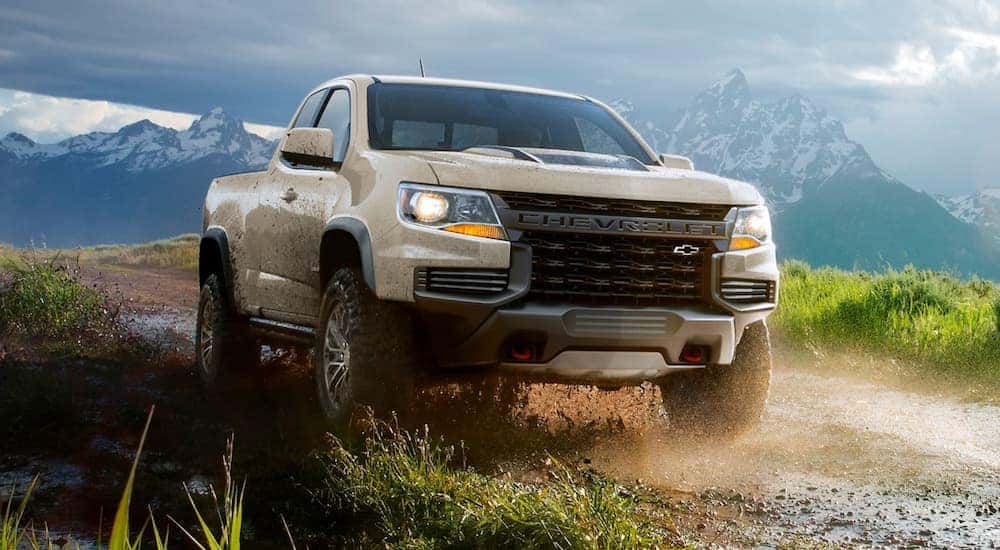 A tan 2021 Chevy Colorado ZR2 kicking up dirt while off-roading.