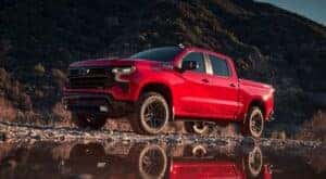 A red 2024 Chevy Silverado 1500 LT Trail Boss Z71 parked off-road.