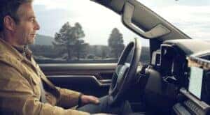 A person is shown utilizing SuperCruise in a 2024 Chevy Silverado 1500.