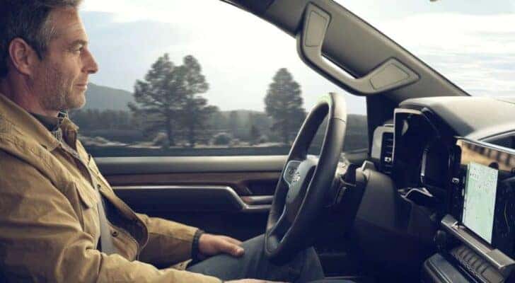 A person is shown utilizing SuperCruise in a 2024 Chevy Silverado 1500.