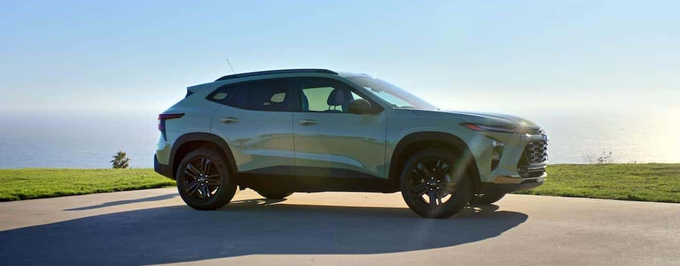 A green 2024 Chevy Trax ACTIV is shown parked on a sunny day.