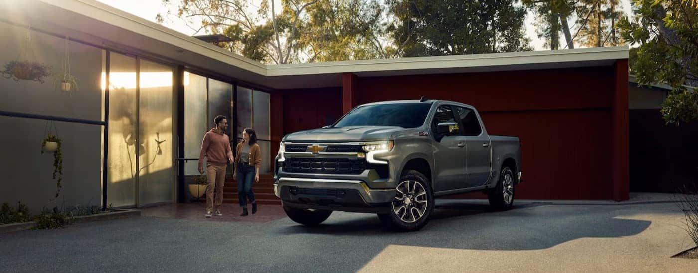 A silver 2025 Chevy Silverado 1500 Z71 is shown parked after visiting a car dealer.