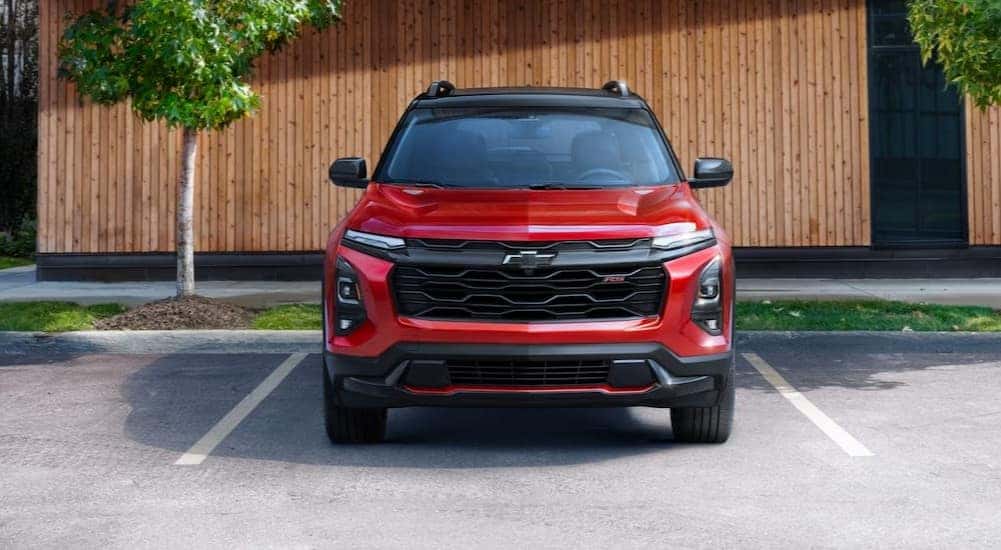 A red 2025 Chevy Equinox RS parked on a sunny day.