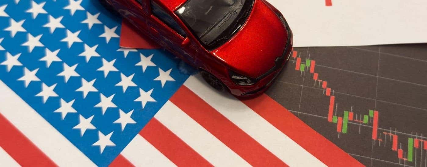A red toy vehicle on an American flag.