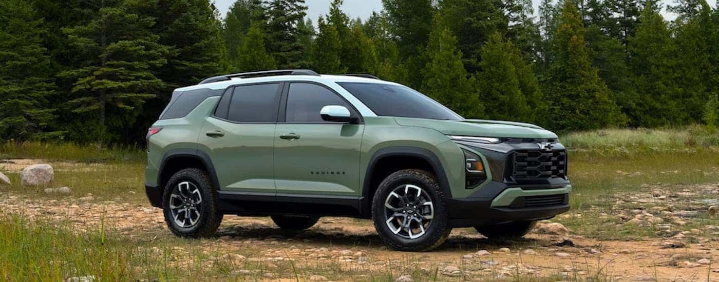 A green 2025 Chevy Equinox ACTIV is shown from the side.
