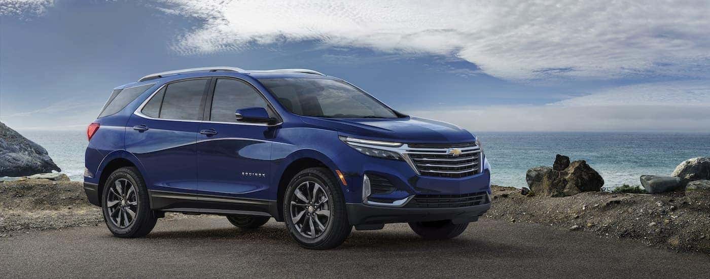 A blue 2022 Chevy Equinox Premier is shown from the side.