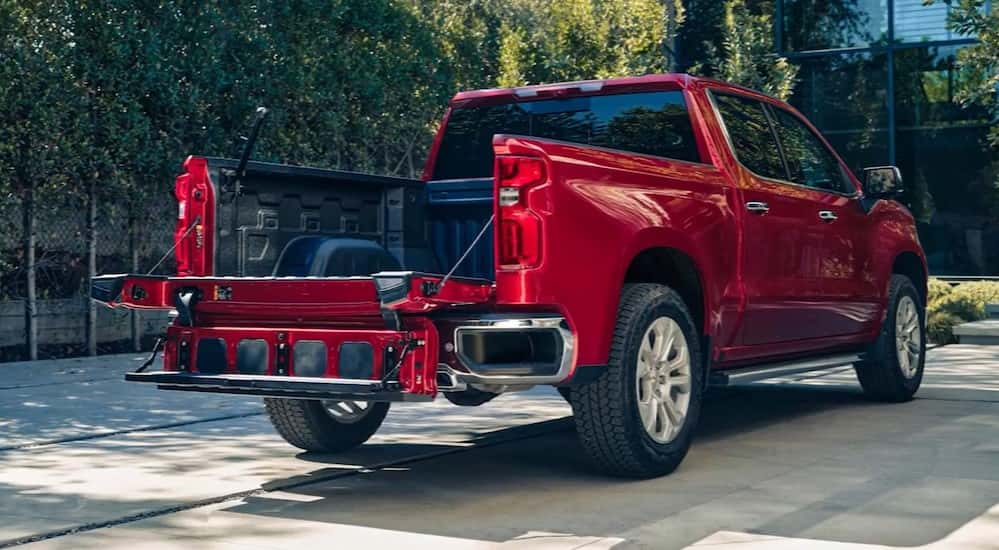 A red 2025 Chevy Silverado 1500 for sale near Mountain Brook parked near a building.